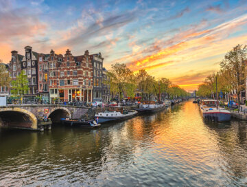 Amsterdam sunset city skyline at canal waterfront, Amsterdam, Netherlands